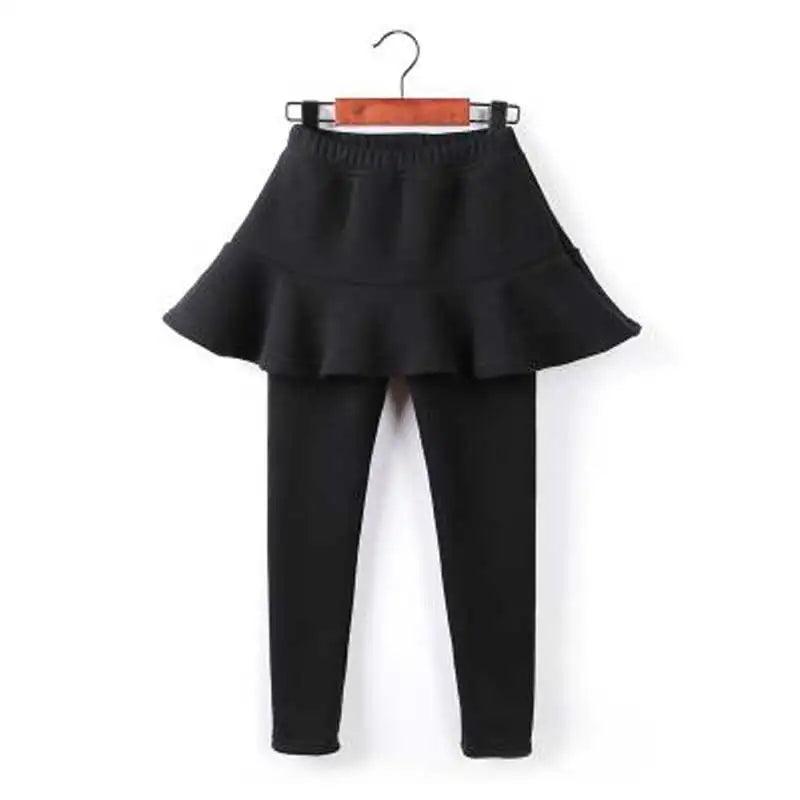 Black children's leggings with an attached ruffle skirt and elasticated waistband on a hanger