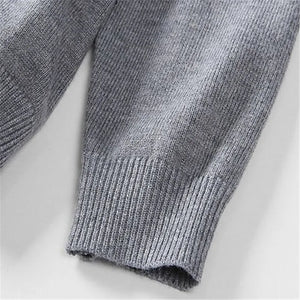 Close-up of the grey knitted sweater cuff and fabric